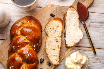 Top view on sweet raisins bun pigtail bread on the decorated wooden background