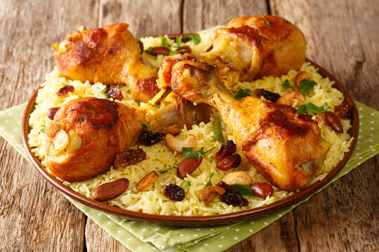 Gourmet food Majboos is a traditional dish of Arabian rice and chicken close-up in a plate on the table. horizontal