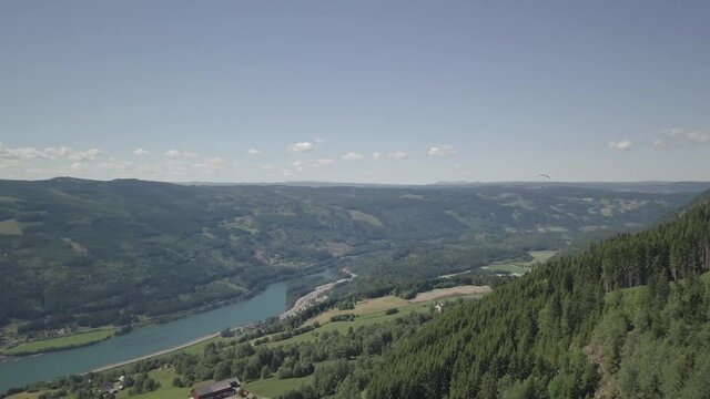 Aerial view of a man parasailing over fjords of Norway - tracking, drone shot
