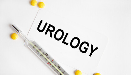 Obraz premium On the card the text urOLOGY, next to the thermometer and yellow tablets.