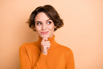 Portrait of young attractive beautiful thoughtful happy girl thinking look copyspace isolated on beige color background