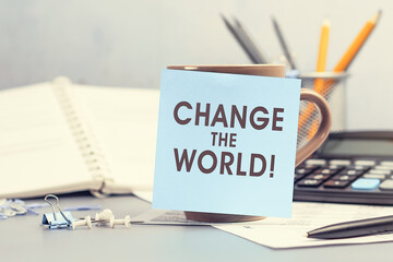 Change the world - concept of text on sticky note