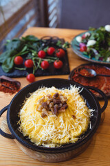 banosh, a traditional Ukrainian corn grain dish with fat and sheep cheese.