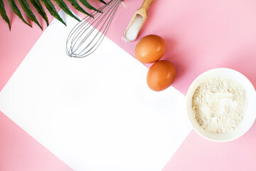 Ingredients for cooking baking - flour, egg, sugar, rolling pin on pink background. Concept of cooking dessert.
