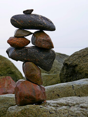 the art of balancing stones, stacked on a big stone on the beach