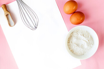 Ingredients for cooking baking - flour, egg, sugar, rolling pin on pink background. Concept of cooking dessert.