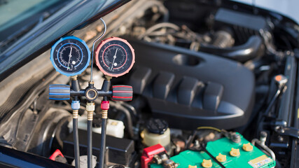 Fototapeta premium Car air conditioner check service, leak detection, fill refrigerant.Device and meter liquid cooling in the car by specialist technicians.