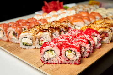 Set of various sushi rolls on a board. Close-up, selective focus