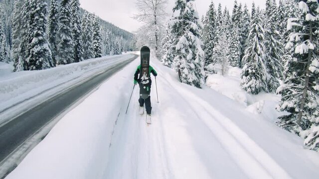 Ski Hiking POV Along Mountain Highway on Snowy Trail