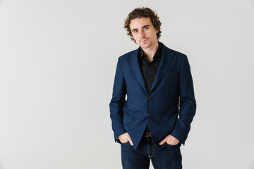 Confident handsome man in jacket posing and looking at camera