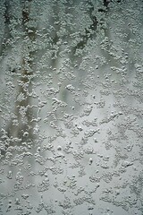 Wet snow on the window pane. Water and ice texture