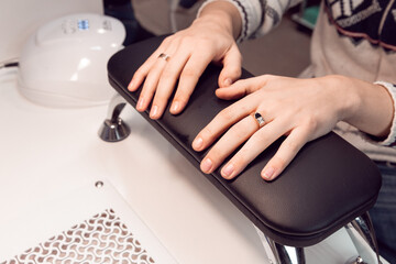 A man in a beauty salon, having a manicure procedure. Male hands before the hardware manicure procedure. Men's manicure.