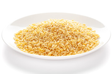 Crunchy Moong Dal in a white ceramic plate, made with roasted Mung bean. Pile of Indian spicy snacks (Namkeen), under backlight, side view