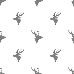 seamless winter pattern with black deer heads with antlers.