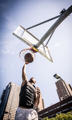 Basketball player making huge slam dunk