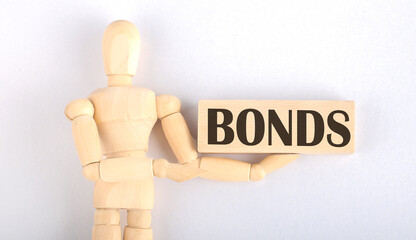 Wooden man shows with a hand to block with text BONDS