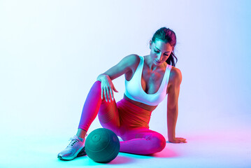 Woman training with the exercizes ball in the gym