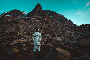 Astronaut exploring a new planet. Searching for a new home for humanity. Concept about science and...