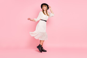 Full length photo of carefree lady dance look empty space wear retro hat dotted dress footwear isolated pink color background