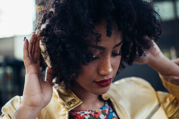 Beautiful latin woman with curly hair, portrait set in the city
