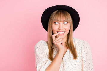 Photo of tricky coquette lady bite finger look empty space wear vintage hat dotted blouse isolated...