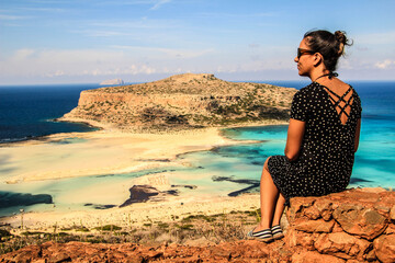 latina brunette girl on a cliff overlooking the beach	