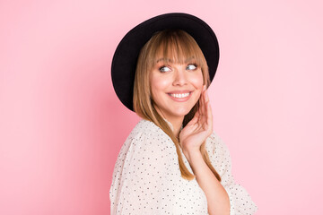Photo of funny dreamy lady palm cheek look empty space wear retro hat dotted blouse isolated pink color background