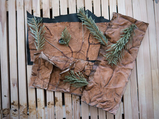 Leather pieces made of fresh zombie skin with scars stitched with dark brown thread and green...