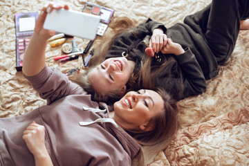 Top view of beautiful mom with her cute daughter are having fun at home