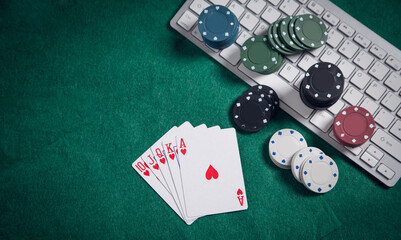 Computer keyboard, playing cards and chips. Online casino