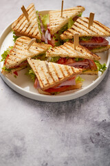 Appetizing fresh and healthy grilled club sandwiches with ham and cheese