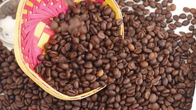 Dropping coffee beans over a craft bowl, Craft bowl filled with coffee beans