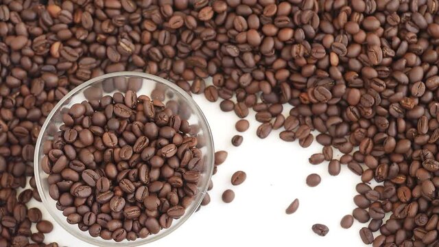Close shot of dropping glass bowl filled with coffee beans, View of coffee seeds
