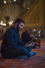 A man reciting Quran in Blue mosque (Sultan Ahmed mosque) Istanbul Turkey 