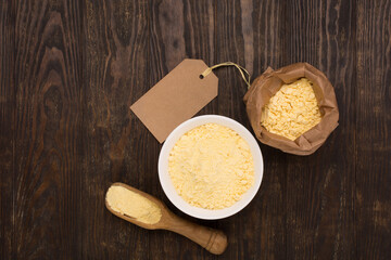 Chickpea flour on dark wooden background. Top view, copy space.