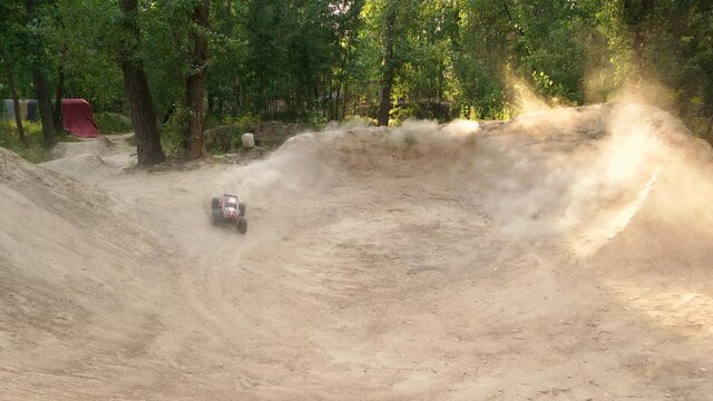 RC toy buggy car moving around and making smoke. Test drive of radio controlled car making a lot of dust.