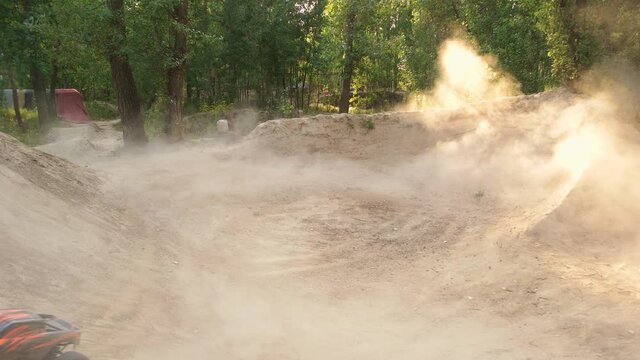 Monster rc car driving around making smoke. Radio controlled monster truck on the sand.