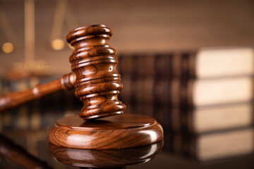 Law symbols composition on brown background. Gavel, scale, legal books and Themis sculpture. Place...