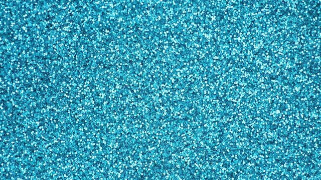 Shimmer small round blue glitter abstract background in close-up. Surface in high-gloss sparkling blue glitter in macro. Christmas background.