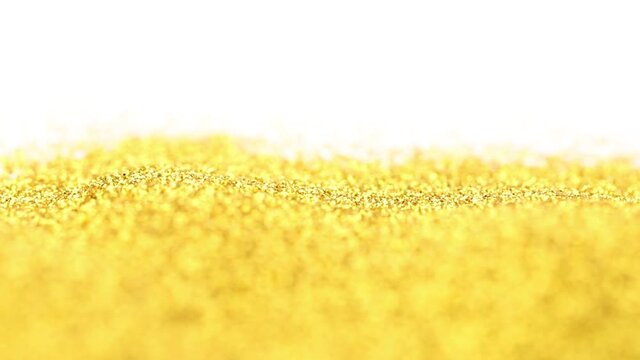 Falling golden fine glitter. Forms a pile of sparkling shimmery gold glitter.
