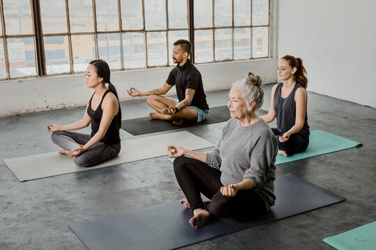 Diverse People Meditating In A Yoga Class