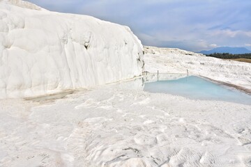 Amazing travertine pools and terraces in Pamukkale. Cotton castle in Turkey, Denizli Province. Beautiful natural view of famous white rocks in Pamukkale