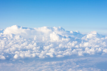 Incredible view of fluffy clouds from the height of the plane.