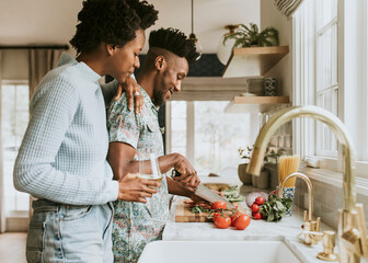 Black couple cooking in the kitchen