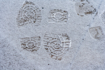 Lots of footprints in snow. danger walking in the snow. Many footprints in the winter ground. Shoe marks outdoor