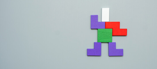 Man shape block of colorful wood puzzle piece on gray background. logical thinking, business logic, Conundrum, decision, solutions, rational, and idea concepts