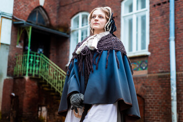 Outdoors portrait of a victorian lady walking old city