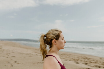 Fototapeta na wymiar Woman meditating on the beach
