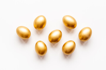 Golden Easter eggs isolated on white background. Top view