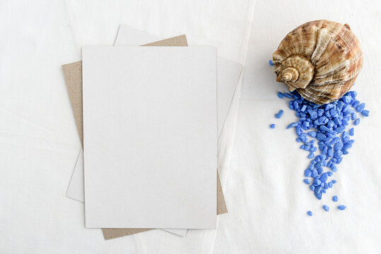 Fashionable stock stationery background - white map and seashells on a white table. Romantic background. Blank for an invitation card.